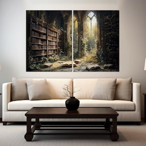 May include: A two-panel wall art set depicting a dark, overgrown library interior with tall bookshelves, open books scattered on a stone floor, and large arched windows letting in golden light, displayed above a cream-coloured sofa.