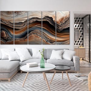 a modern living room with a large abstract painting on the wall, a gray sofa, a round coffee table, and a glass-walled bathroom visible in the background.