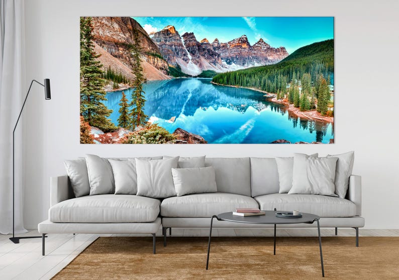 May include: A panoramic view of a mountain lake with snow-capped peaks reflected in the turquoise water. Lush green trees line the shore, creating a serene and picturesque landscape.
