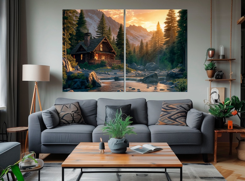 May include: A split canvas print depicting a rustic cabin situated in a woodland setting. The cabin has a wooden exterior and a warm glow emanating from its windows. The background shows a lush forest with a river flowing through it. The sky is a vibrant orange and yellow, suggesting a sunset.