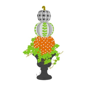 May include: A stack of three pumpkins in a black urn with green ivy. The pumpkins are decorated with different patterns: black and white checkered, white with green leaves, and orange with white polka dots.
