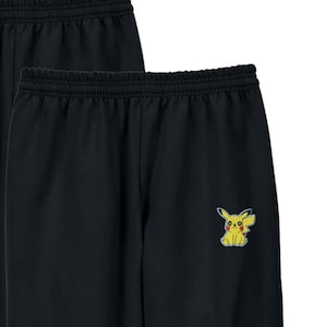 May include: Black sweatpants with a yellow Pikachu character embroidered on the left leg.