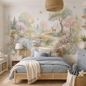 May include: A bedroom featuring a large watercolour wall mural of a forest landscape with a pond, a swan, a deer, and trees. The room includes a light wood bed frame with a blue quilt, a blue dresser, a white nightstand, and a window bench with pillows.