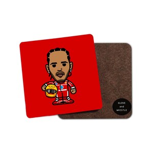 May include: A red square coaster with a cartoon illustration of a race car driver wearing a red racing suit and holding a yellow helmet. The text "GLOVE and WHISTLE" is printed on the coaster.
