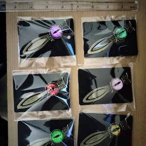 May include: Set of six antique gold bookmark with a single eye design. The eyes are in different colors: purple, green, red, pink, green, and brown.