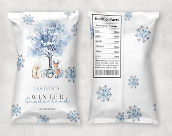 May include: A white paper bag with a blue and white winter wonderland theme. The bag features a snowy tree, a polar bear, a penguin, and a deer. The bag also has the text "Jaston's Winter Wonderland" and the date "23.12.2023". The back of the bag has a nutrition facts label with the text "FUN 100%, CAKE 100%, SMILES 100%, FRIENDS 100%, FAMILY 100%, LOVE 100%".