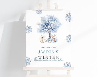 May include: Welcome to Jaston's Winter Wonderland sign with a blue and white watercolour design featuring a snowy tree, a polar bear, a penguin, and a deer.