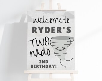 May include: A grey and white welcome sign with a cartoon tornado and the text "Welcome to Ryder's Two-nado 2nd Birthday!"