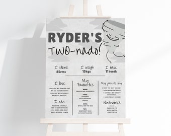 May include: A monochrome poster on an easel, with the words "RYDER'S Two-nado!" and a cartoon tornado. The poster lists personal details: 85cm tall, 15kg, 11 teeth, favourite things, and nicknames.