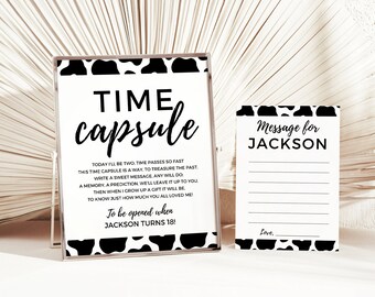 May include: Black and white cow print time capsule sign with the text "TIME capsule" and "To be opened when JACKSON TURNS 18!"  A separate black and white cow print card with the text "Message for JACKSON" and a lined space for writing a message.