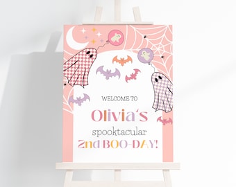 May include: A pink and white welcome sign with a spooky theme. It says "Welcome to Olivia's spooktacular 2nd BOO-DAY!" and features ghosts, bats, and spiderwebs.