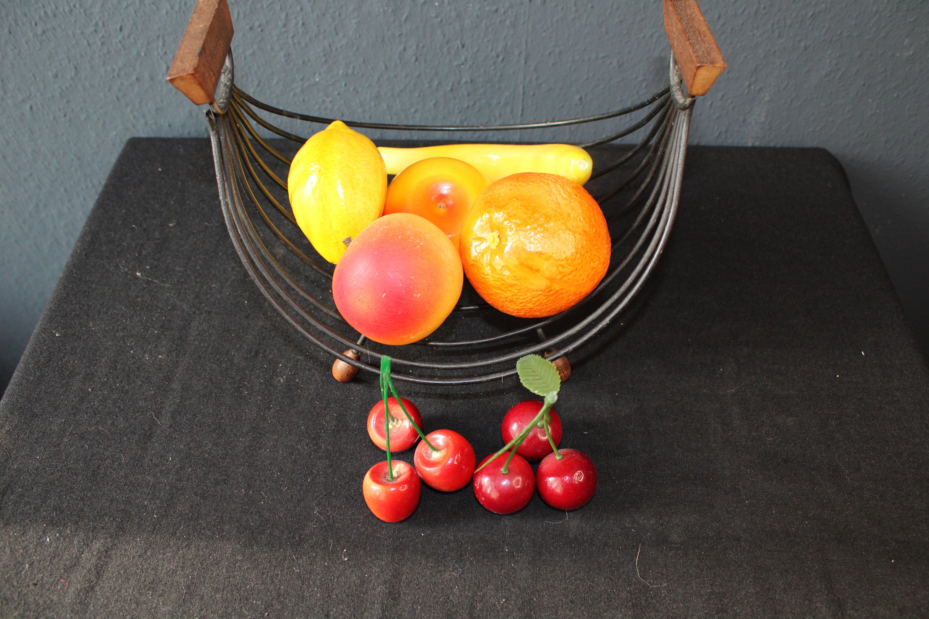 Mid Century String Fruit Basket filled with artificial fruit.