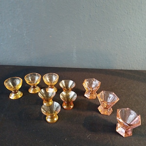 Various sets of antique shot glasses.