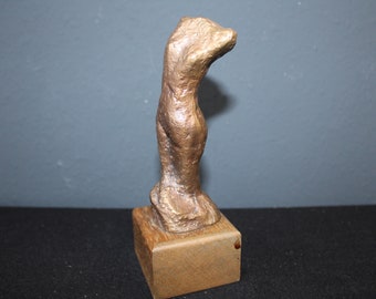 Escultura moderna en bronce sobre base de madera, figura abstracta, torso femenino