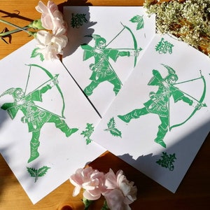 Robin Hood linoprint unframed. Monochrome green linocut print of a Nottingham icon and legend with oak leaf and hornbeam leaf border detail.