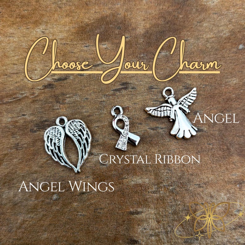 May include: Three silver-toned metal charms labeled Choose Your Charm. The charms include a pair of angel wings, a ribbon shape embedded with small clear crystals, and a stylized angel figure with outstretched wings and a small hanging loop.