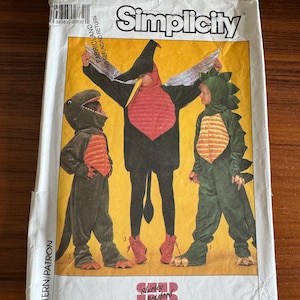 May include: Simplicity pattern for children's costumes. The cover shows three children in dinosaur and bird costumes. The costumes are in shades of green, black, and red. The pattern is size 10-12. The brand name is Simplicity.