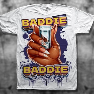 Könnte beinhalten: Weißes T-Shirt mit einem Grafikdruck einer Hand, die ein Schnapsglas hält, mit dem Text "Baddie Shot O'Clock" in Gelb und Lila.