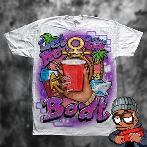 May include: White t-shirt with a colorful graphic design featuring a hand holding a red solo cup, an anchor, a cruise ship, palm trees, and the text "Let Me Drive That Boat".