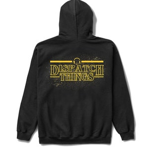 May include: Black hooded sweatshirt with a yellow graphic print that says "DISPATCH THINGS" with a headphone icon above the text.