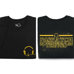 May include: Two black t-shirts with a yellow graphic design. One shirt features a headset with a heartbeat line and the other shirt features the text "DISPATCH THINGS" with a headset above the text.