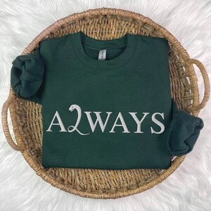 May include: A dark green sweatshirt with the words "A2WAYS" in white lettering. The "A" is stylized with a snake.