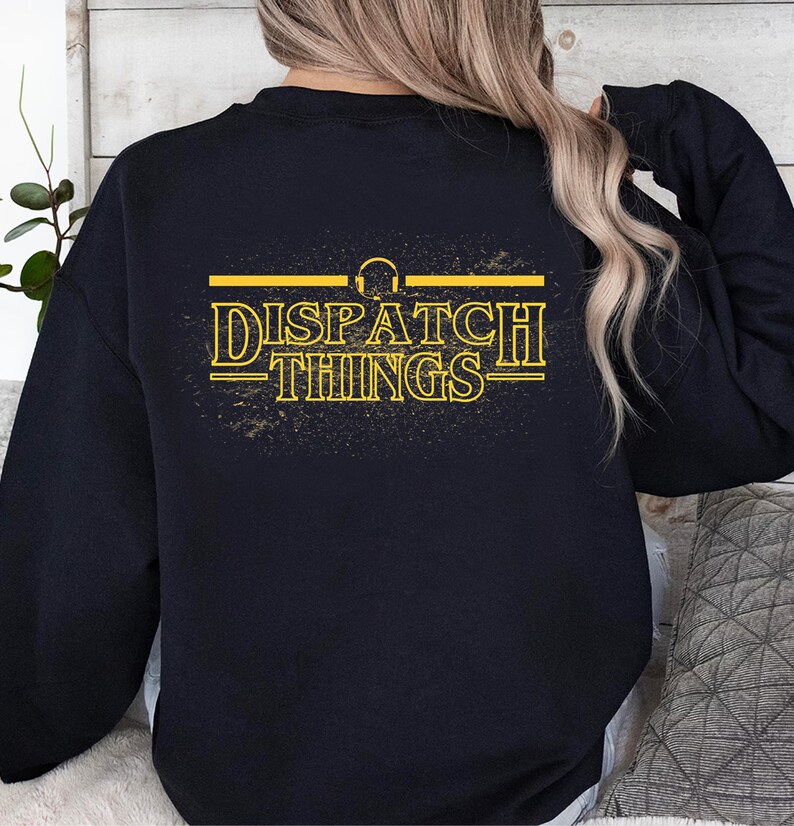 May include: Black sweatshirt with a yellow graphic that says "DISPATCH THINGS" with a headphone symbol above the text.