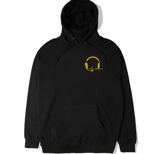 May include: Black hooded sweatshirt with a gold graphic of a headset with a heartbeat line.