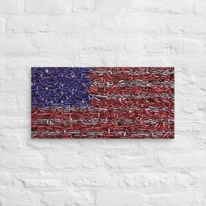 May include: An American flag made entirely of bullet casings. The casings are arranged in the traditional red, white, and blue pattern of the American flag.