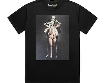 May include: A black short-sleeved t-shirt featuring a central graphic print of a male figure standing behind a female figure with visible stitches on the body. The inner neck label displays the text frankkree8.com in white and yellow lettering.