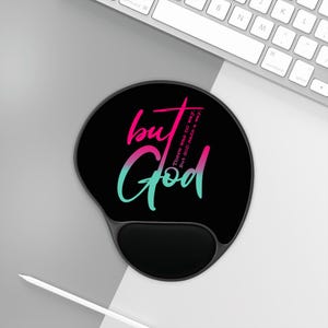 May include: Black ergonomic mouse pad with a wrist rest. The pad features the words "but God" in a gradient of pink and teal, with the text "There was no way. But GOD made a way." in a smaller font.