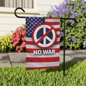 May include: A garden flag with the American flag design, a peace symbol, and the words "NO WAR". The flag is mounted on a black metal stand, set in a garden with green grass and colorful flowers in the background.
