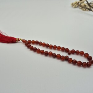 Natural red aqeeq tasbih , red agate tasbih , 33 beads agate tasbih , rosary beads , agate rosary , agate prayer beads , red carnelian agate prayer beads , natural yemeni aqeeq tasbih , Islamic agate tasbih , 33 beads tasbih , red agate tasbih , gifts for Muslim,  yemeni aqeeq tasbih , agate prayer beads , rosary beads , Muslim prayer beads , Islamic prayer beads , round aqeeq beads tasbih , agate beads tasbih , gifts for Muslim friends , Islamic gifts,  Islamic aqeeq tasbih ,rosary beads ,beads