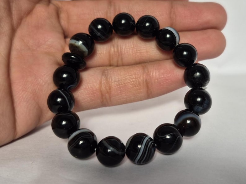 Black Agate beads, round aqeeq Bracelet ,suleimani aqeeq Bracelet , Bracelet , black agate , agate beads , round beads , Islamic necklace, natural aqeeq , Yemeni aqeeq , agate Bracelet , round aqeeq beads , aqeeq natural beads , natural stone , banded agate bracelet,  aqeeq beads bracelet,  round beaded bracelet,  beautiful gifts , best gifts for her , gifts for brother  , gifts for him , casual wear bracelet,  everyday wear bracelet,  aqeeq jewelry, yemeni aqeeq,  aqiq Bracelet, agate Bracelet,