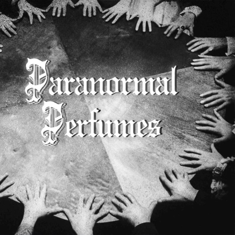 May include: A black and white image of a group of hands reaching up towards the centre of the image. The text "Paranormal Perfumes" is written in a gothic font in the centre of the image.