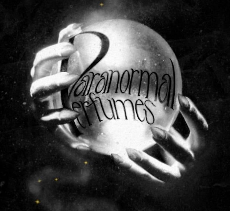 May include: A black and white image of two hands holding a crystal ball with the text "Paranormal Perfumes" written on it.