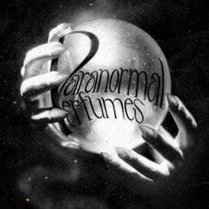 May include: A black and white image of two hands holding a crystal ball with the text "Paranormal Perfumes" written on it.