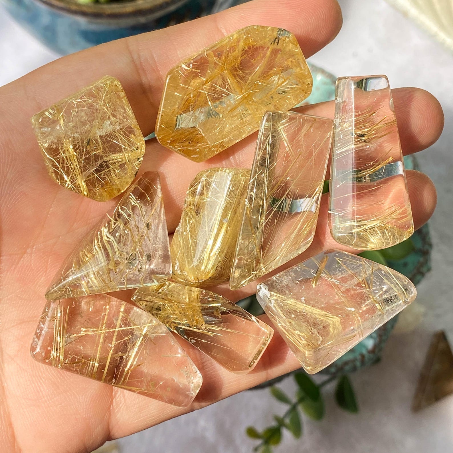Golden rutilated quartz cabochons with fine needle-like inclusions, aligned with Virgo's clarity
