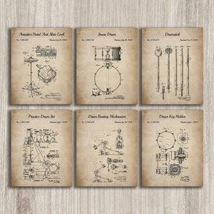 May include: Six vintage-style patent drawings for drum parts, including a pedal anti-slide lock, snare drum, drumstick, practice drum set, drum beating mechanism, and drum key holder. The drawings are in black and white and have a faded, aged look.