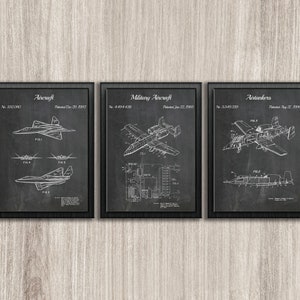 May include: Set of three framed aviation patent prints. The prints feature detailed diagrams of aircraft, military aircraft, and air tankers. Each print is in black and white, with the title and patent information at the top. The frames are black.