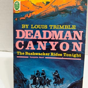 May include: A vintage paperback book titled "Deadman Canyon" by Louis Trimble. The cover features a pink title, a mountain scene, and illustrations of cowboys on horseback. The book is a "Double Novel" and priced at 40¢.