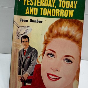 May include: Vintage paperback book cover for "Yesterday, Today and Tomorrow" by Jean Dunbar. The cover features a woman with red hair and blue eyes, a man in a suit, and a red chair. The book is part of the Harlequin Romance series.