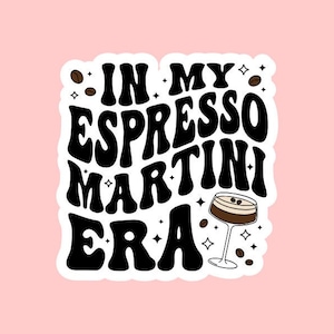 May include: A white sticker with black text that reads "In My Espresso Martini Era" with a small illustration of an espresso martini glass with coffee beans scattered around it.