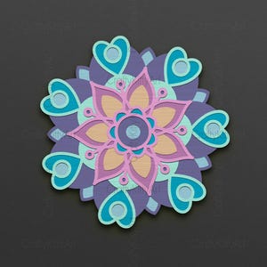 May include: A colourful mandala design with a pink flower in the centre, surrounded by teal and purple hearts.