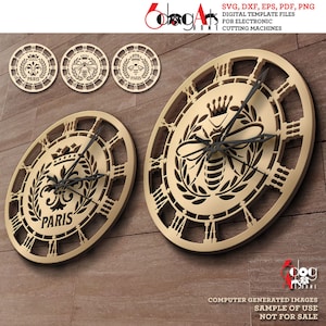 May include: A set of three clock face designs featuring a bee, a crown, and a fleur-de-lis with the word "PARIS" underneath. The designs are in a gold color and have a decorative, intricate style.