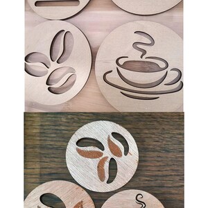 May include: Six round wooden coasters with various coffee-themed designs. The designs include coffee beans, a steaming cup of coffee, and the word "coffee".