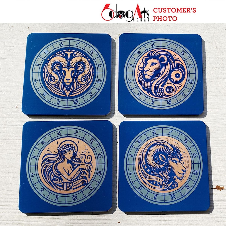 May include: Four blue square coasters with a gold zodiac symbol on each. The symbols are Aries, Leo, Virgo, and Capricorn.