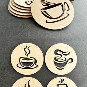 May include: Set of four wooden coasters with coffee cup designs. One coaster features a coffee cup with steam, another has two coffee beans, and the other two have a coffee cup with steam and the word "Coffee".
