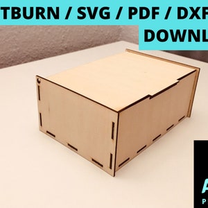 May include: A wooden box with a hinged lid, designed for laser cutting. The box is made of light-colored wood and has a simple, rectangular shape. The image includes the text "LIGHTBURN / SVG / PDF / DXF / AI DOWNLOAD".