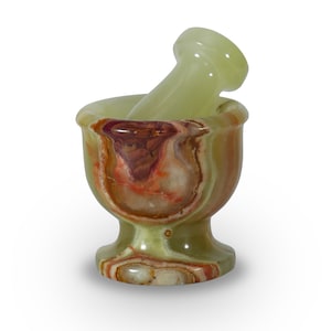 May include: A small, decorative mortar and pestle set. The mortar is a bowl shape with a pedestal base, and the pestle is a rounded cylinder. The set is made of a green, brown, and red swirled stone.